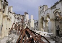 40 Officials DEAD — Iran’s Security Apparatus Crumbling Interior view of a destroyed building with collapsed arches and debris