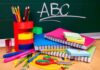 A collection of colorful school supplies including notebooks, pens, and scissors on a desk