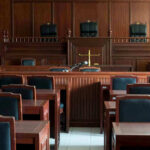 Illegal Alien Ran Schools—Then This Empty courtroom with wooden furnishings and judges bench.