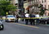 Police gathered at an urban crime scene.