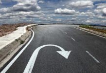 Curved road with a U-turn arrow marking.