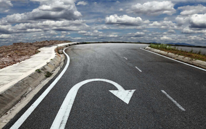 Curved road with a U-turn arrow marking.