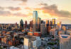 City skyline at sunset with modern skyscrapers.