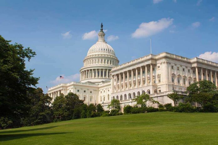 The U.S. Capitol building surrounded by green grass and trees under a blue sky