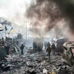 Russia’s Deadly Kyiv Assault: More To Come? A chaotic protest scene with smoke, fire, and people holding flags
