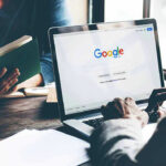 German Court SLAPS Google’s AI Laptop on Google homepage, person reading a book.