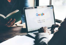 Laptop on Google homepage, person reading a book.