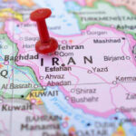 War, Cash, Silence — The Iran Draft Red pushpin marking Iran on a map.