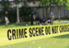 $45M Cocaine Tunnel Hidden Under Fake San Diego Discount Store Yellow crime scene tape blocking grassy area.