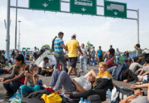 The Foreign Policy Hawk Warning About Jewish Refugees — And Why It Matters People sitting and resting on a highway.