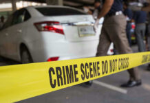 The Six-Day-Old Baby Who Never Got to Come Home Safely Crime scene tape blocking off white sedan.