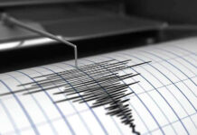 Seismograph needle recording earthquake activity on paper.