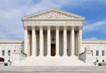 The Retirement That Isn’t Happening — Media Keeps Saying It Is Front view of the Supreme Court building with large columns and steps under a blue sky