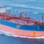 Oil Choke Point Under Fire—Prices Next? Large cargo ship navigating through the ocean
