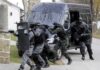 FBI Shoots Man With Fake Bomb — All 10 Hostages Walk Out Safe SWAT team members in tactical gear responding to a situation