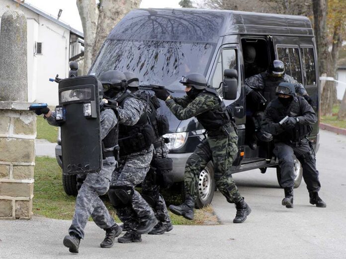 Special,Force,Police,In,Action SWAT team members in tactical gear responding to a situation