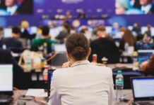 Situation Room Audio — Who Leaked It? View of a conference room filled with attendees focused on their laptops