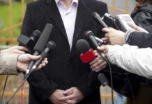 The Reporter’s Question That Triggered a Viral Meltdown A group of microphones surrounding a person at a press conference
