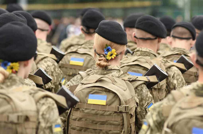 Soldiers in camouflage uniforms with Ukrainian flags.