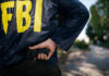 FBI Victory—or Viral Mirage? FBI agent holding a gun behind the back.