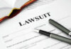 Legal document titled Lawsuit with pen and book.