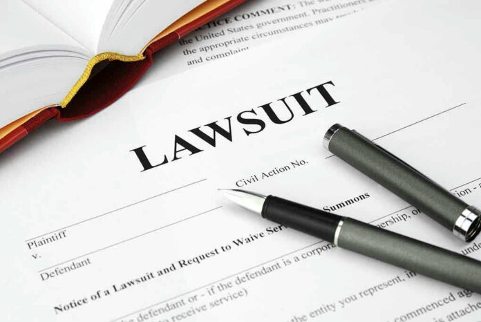 93505339 Legal document titled Lawsuit with pen and book.