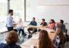 Teacher speaking to students in a classroom discussion