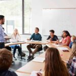 Teacher speaking to students in a classroom discussion