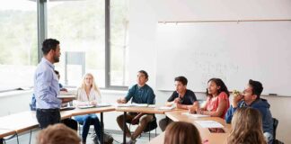 Teacher speaking to students in a classroom discussion