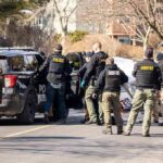One Week Away Triggered a Criminal Charge Police and sheriff officers gather around vehicles on a suburban street
