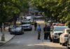 Army Veteran and Wife Found Dead in Alabama Police officers secure a residential street with patrol cars and yellow tape