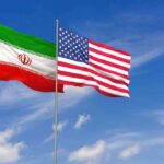 Tehran Signals Talks as War Hits Six Months Iran and United States flags waving on flagpoles