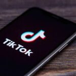 TikTok Death Threat Sparks Federal Takedown smartphone displaying the TikTok app logo on screen