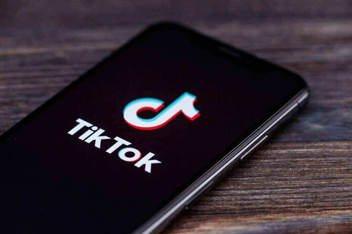 shutterstock_1451827259 smartphone displaying the TikTok app logo on screen