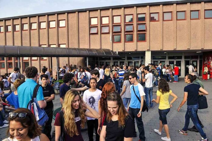 shutterstock_181110272 A large group of students socializing outside a school building