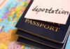 Stack of passports with a note labeled deportation on top, placed on a map