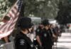 police officer in riot gear standing in a line