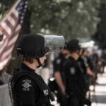 police officer in riot gear standing in a line
