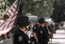 police officer in riot gear standing in a line