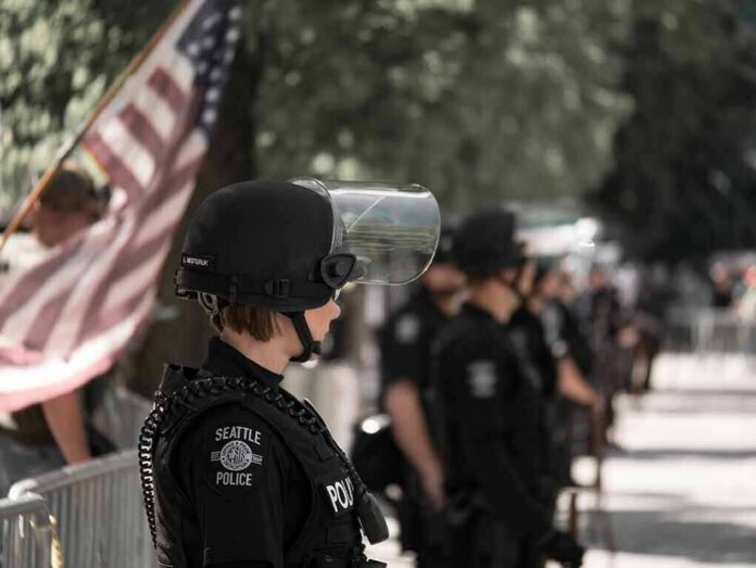 police officer in riot gear standing in a line