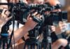 television cameras on tripods at a media event