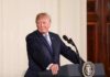 man at podium with presidential seal
