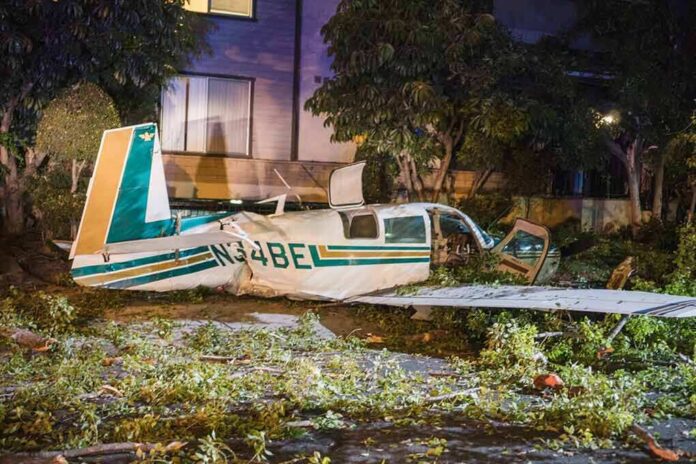 shutterstock_1113505535 small airplane crash in residential area at night