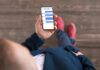 Person holding a smartphone with a messaging app open