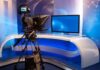 Television studio with camera and news desk