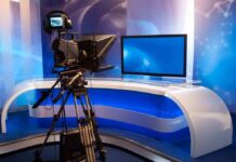 Television studio with camera and news desk