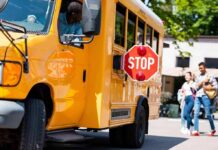 Dad Pulls Gun At Bus Stop, Faces No Charges School bus with extended stop sign near students on sidewalk