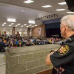 security officer overseeing a crowded school cafeteria