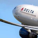 Delta Air Lines commercial jet ascending with wing and engine visible