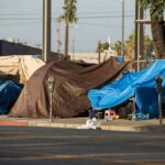 Street tents covered with tarps along a sidewalk